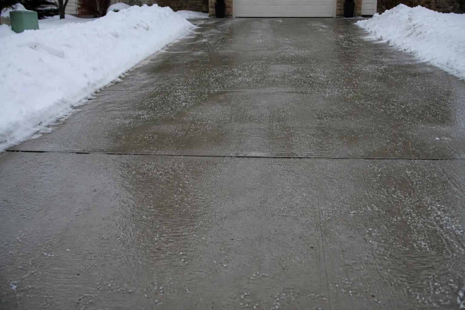 Rock salt on a cleared Rochester driveway